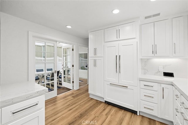 kitchen featuring white cabinetry, visible vents, recessed lighting, and light wood finished floors