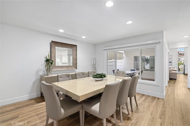 dining area with baseboards, recessed lighting, and light wood-style floors