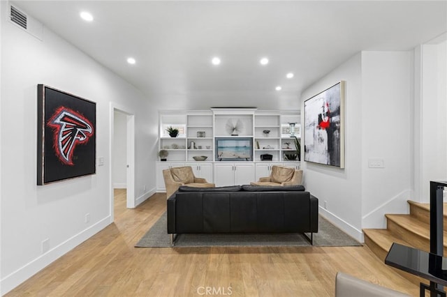 living area with light wood-style floors, baseboards, recessed lighting, and visible vents