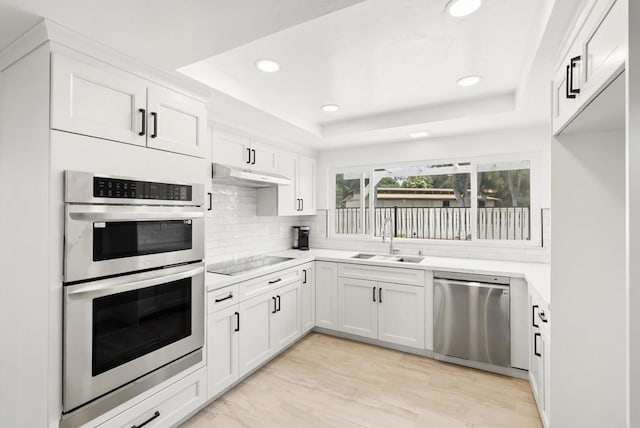 15408 Glentree Rd, Valley Center, CA 92082 - kitchen with appliances with stainless steel finishes, white cabinetry, a raised ceiling, light countertops, and recessed lighting