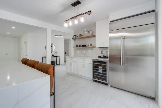 kitchen with open shelves, white cabinetry, decorative backsplash, wine cooler, and stainless steel built in refrigerator