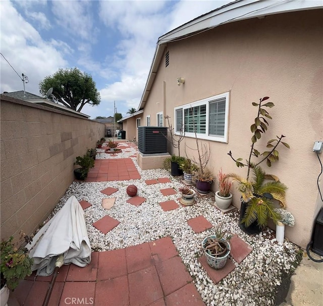19522 Caney Ave, Carson, CA 90746 - view of property exterior with central AC unit, a patio area, stucco siding, and fence