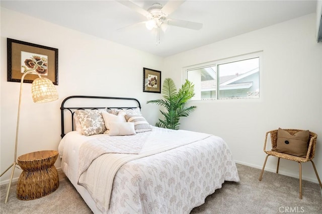 carpeted bedroom featuring a ceiling fan and baseboards
