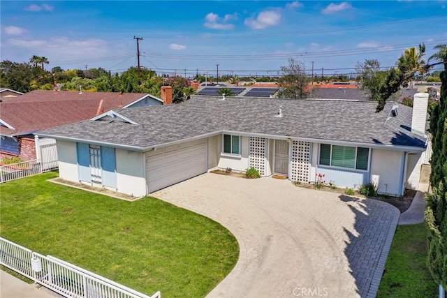 ranch-style home featuring a shingled roof, fence, a chimney, and decorative driveway