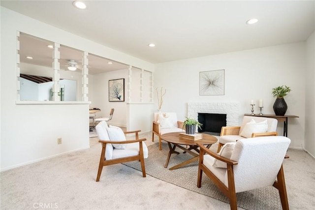 living area featuring recessed lighting, light carpet, and a fireplace