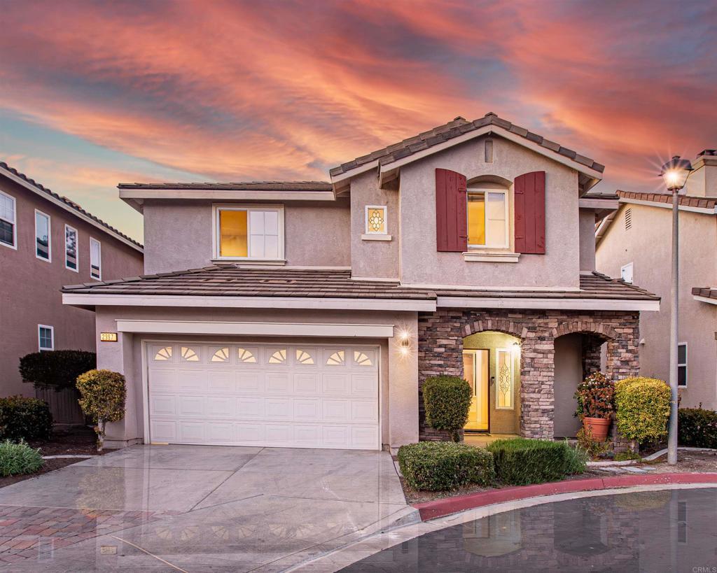 2997 Weeping Willow, Chula Vista, CA 91915 - traditional home with driveway, a tile roof, a garage, stone siding, and stucco siding