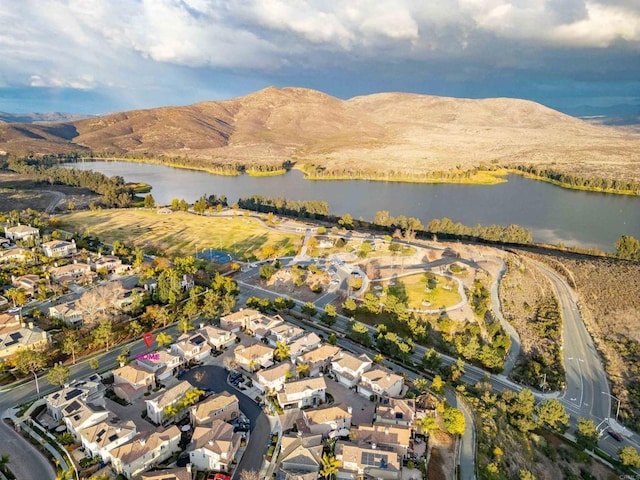 drone / aerial view with a water and mountain view and a residential view