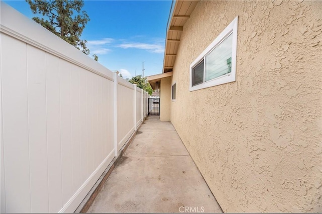 view of property exterior with fence and stucco siding
