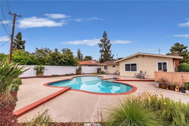 view of pool featuring a fenced in pool, a fenced backyard, and a patio area