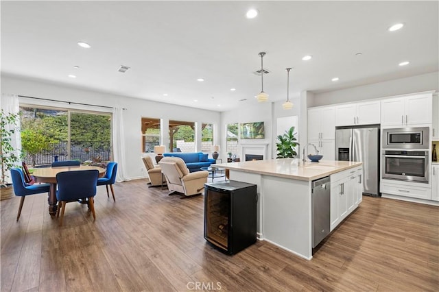 kitchen featuring recessed lighting, light countertops, wood finished floors, and stainless steel appliances