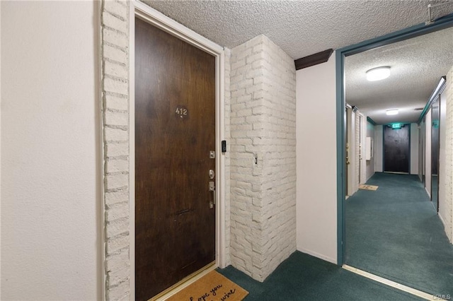 interior space with carpet floors, baseboards, and a textured ceiling