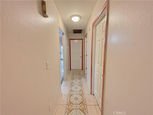 2901 Flint Hills Dr, Bakersfield, CA 93313 - corridor featuring light tile patterned floors, baseboards, a textured wall, and visible vents