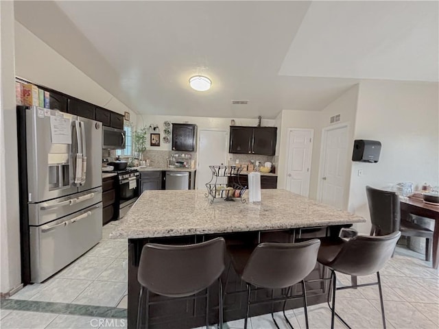 2901 Flint Hills Dr, Bakersfield, CA 93313 - kitchen with a kitchen breakfast bar, a kitchen island, visible vents, tasteful backsplash, and stainless steel appliances