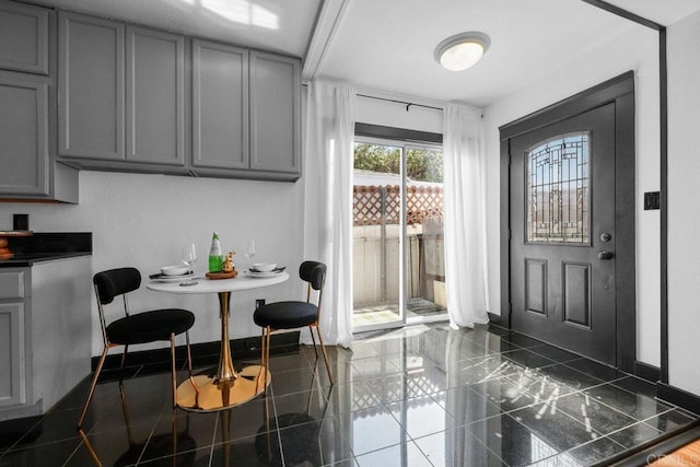interior space featuring baseboards and granite finish floor