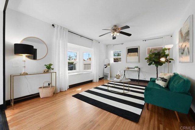 living area featuring ceiling fan and wood finished floors