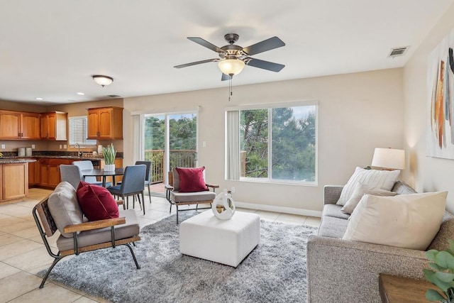 living room with light tile patterned flooring, ceiling fan, recessed lighting, baseboards, and visible vents