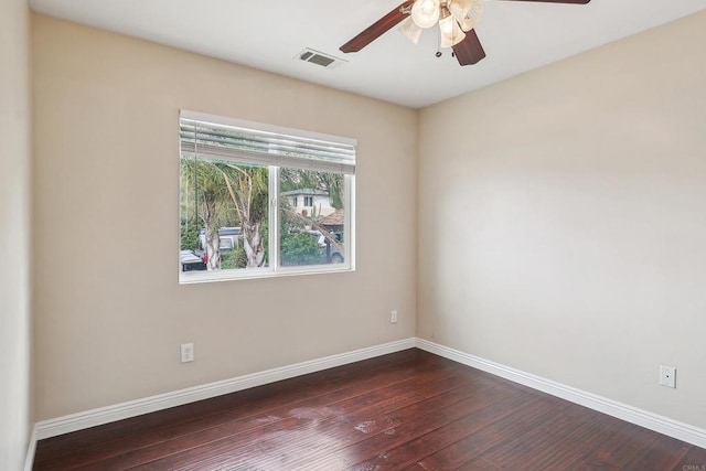 unfurnished room with visible vents, baseboards, ceiling fan, and dark wood-style floors