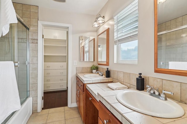 bathroom featuring tile patterned floors, bath / shower combo with glass door, and vanity