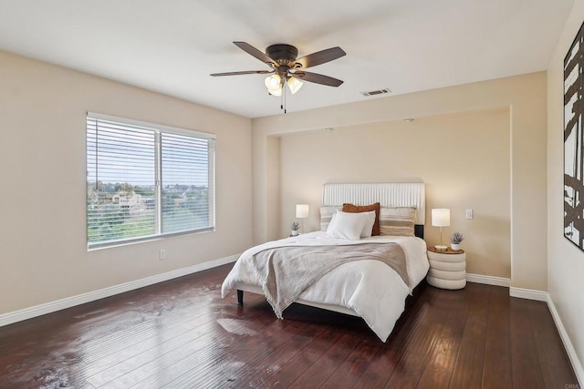bedroom featuring baseboards, a ceiling fan, hardwood / wood-style floors, and visible vents