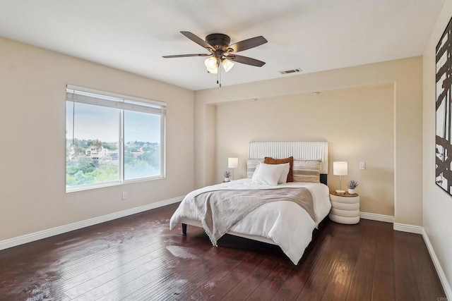 bedroom with baseboards, ceiling fan, hardwood / wood-style floors, and visible vents