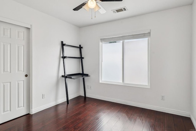 unfurnished bedroom with baseboards, a ceiling fan, wood finished floors, and visible vents