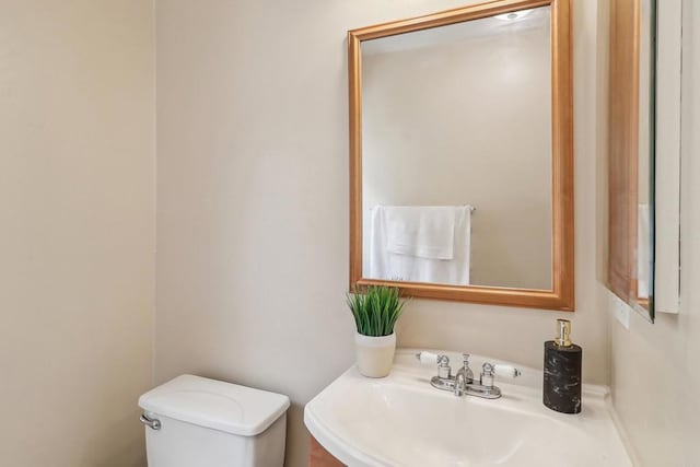 half bathroom with toilet and a sink