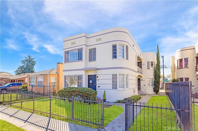 1144 W 57th St, Los Angeles, CA 90037 - art deco inspired home featuring stucco siding, fence private yard, and a front lawn