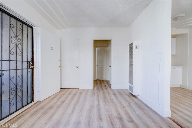 1144 W 57th St, Los Angeles, CA 90037 - entrance foyer with baseboards, a heating unit, and wood finished floors