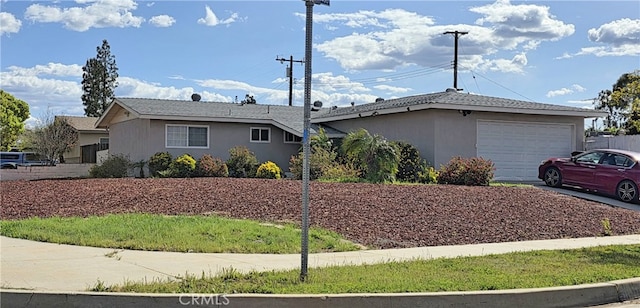 single story home with driveway, stucco siding, and a garage