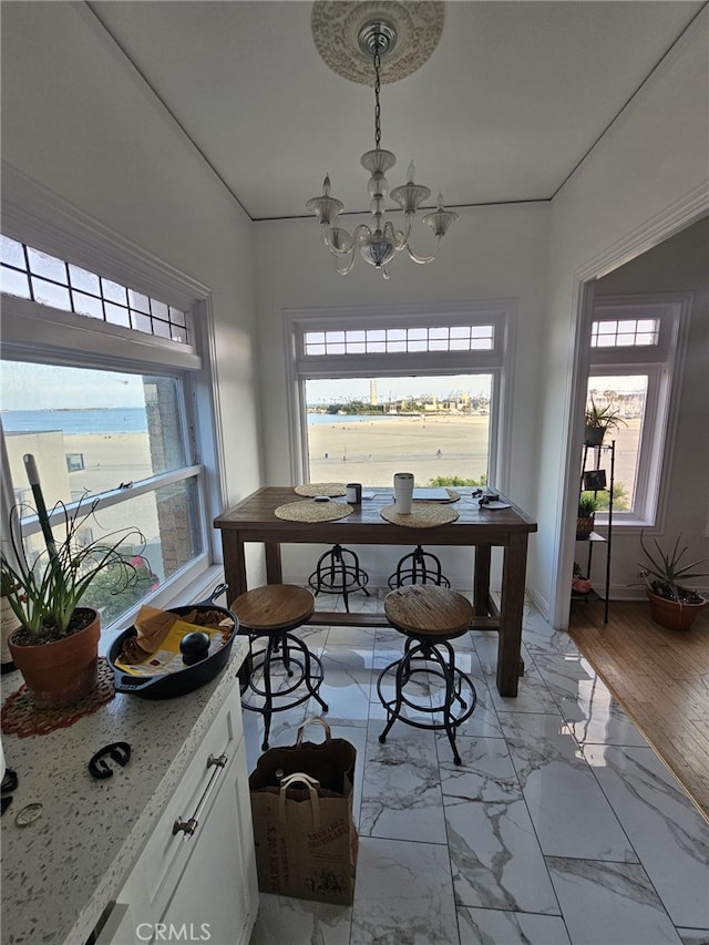 1030 E Ocean Blvd Unit 210, Long Beach, CA 90802 - dining room with a chandelier, healthy amount of natural light, and light marble finish flooring