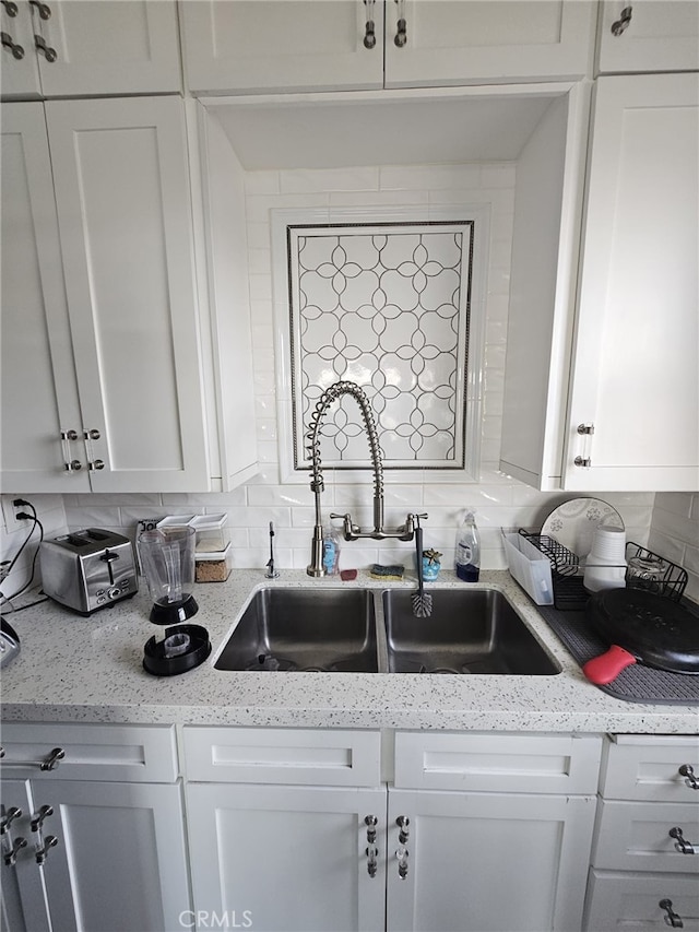 1030 E Ocean Blvd Unit 210, Long Beach, CA 90802 - kitchen with backsplash, white cabinets, and light stone countertops