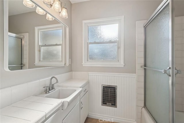17048 Baltar St, Lake Balboa, CA 91406 - bathroom with vanity, enclosed tub / shower combo, a wainscoted wall, and visible vents