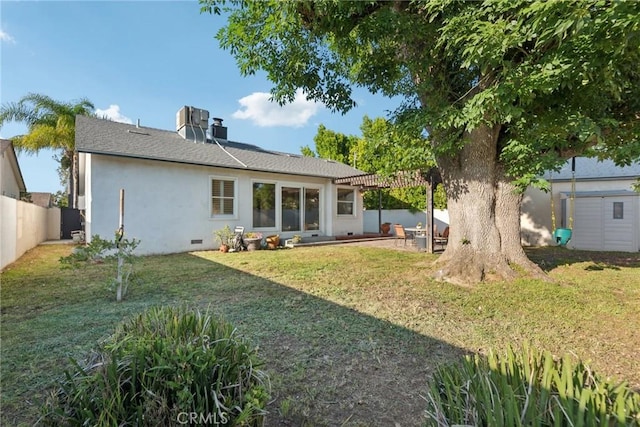 back of house with a pergola, stucco siding, a fenced backyard, a patio area, and a lawn