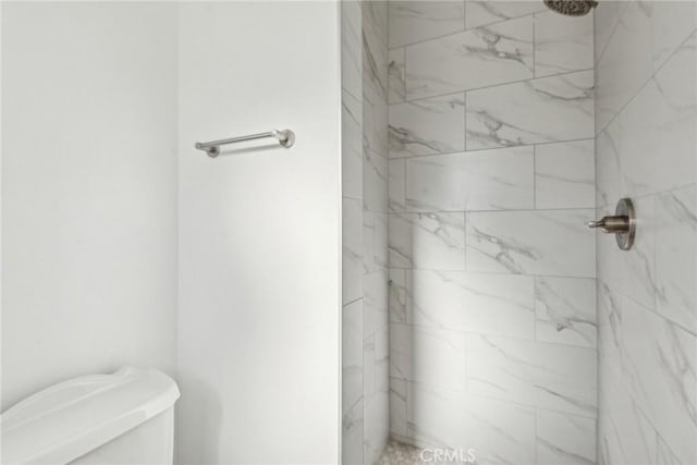 full bathroom featuring a marble finish shower and toilet