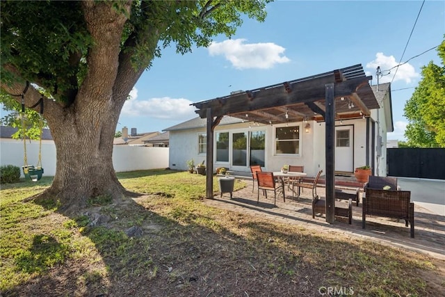 back of house with a lawn, a fenced backyard, a patio, a pergola, and stucco siding