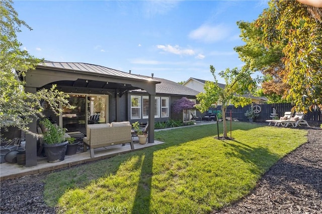 view of yard with outdoor lounge area, a patio area, and fence