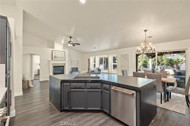 kitchen with dishwasher, a sink, ceiling fan with notable chandelier, dark wood-style floors, and open floor plan