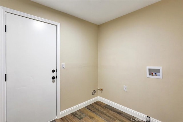clothes washing area with laundry area, dark wood-style flooring, hookup for a gas dryer, baseboards, and hookup for a washing machine