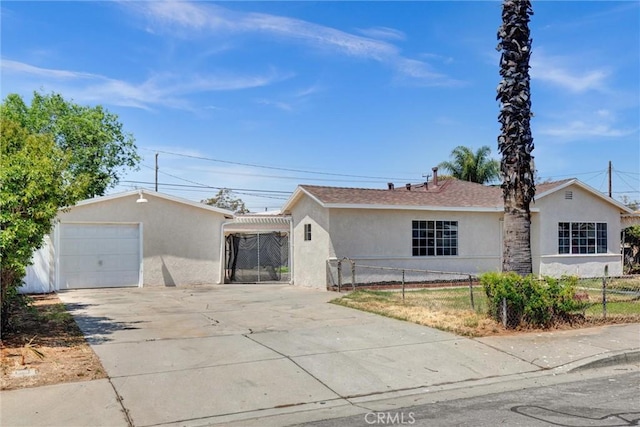single story home with concrete driveway, fence, and stucco siding