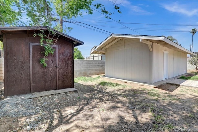 view of shed featuring fence