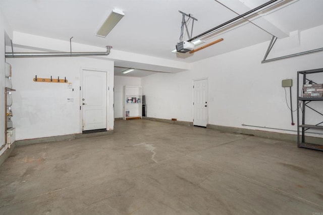 garage featuring baseboards and a garage door opener
