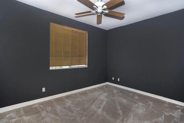 empty room featuring baseboards, carpet flooring, and a ceiling fan