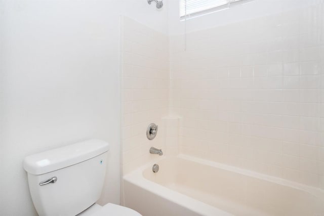 bathroom featuring shower / bathtub combination and toilet