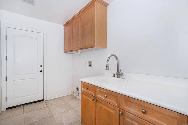laundry area with cabinet space, a sink, hookup for a washing machine, light tile patterned floors, and visible vents