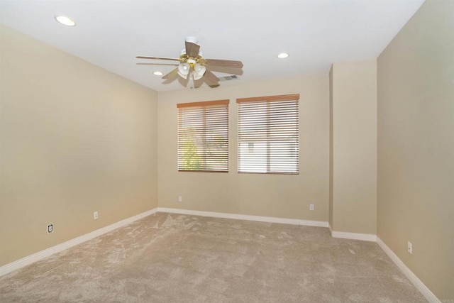 empty room featuring a ceiling fan, recessed lighting, and light colored carpet