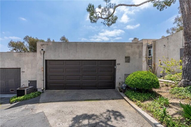 garage featuring driveway and central AC