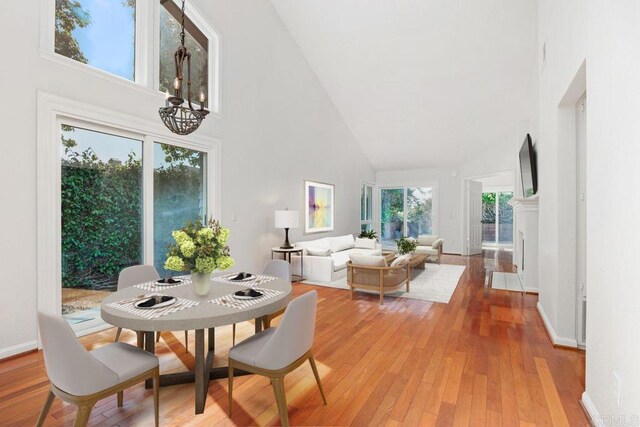 814 Okra Ct, Carlsbad, CA 92011 - dining room featuring high vaulted ceiling, a chandelier, and light wood-style floors