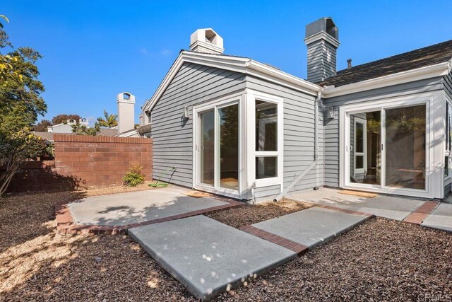 814 Okra Ct, Carlsbad, CA 92011 - back of property with a patio and a chimney