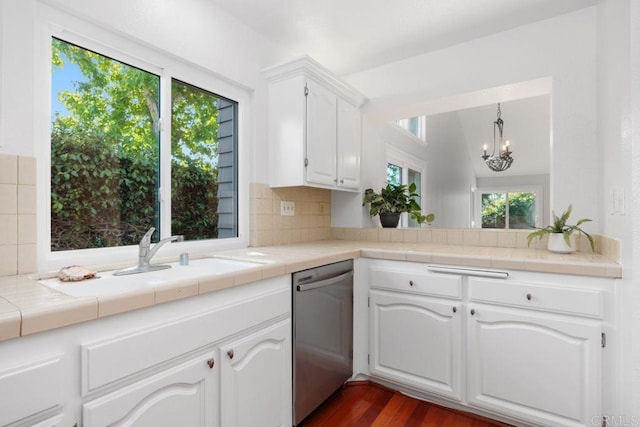 814 Okra Ct, Carlsbad, CA 92011 - kitchen with stainless steel dishwasher, backsplash, white cabinets, dark wood-style flooring, and a chandelier