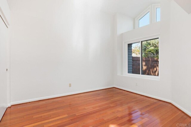 814 Okra Ct, Carlsbad, CA 92011 - unfurnished room featuring wood finished floors and high vaulted ceiling